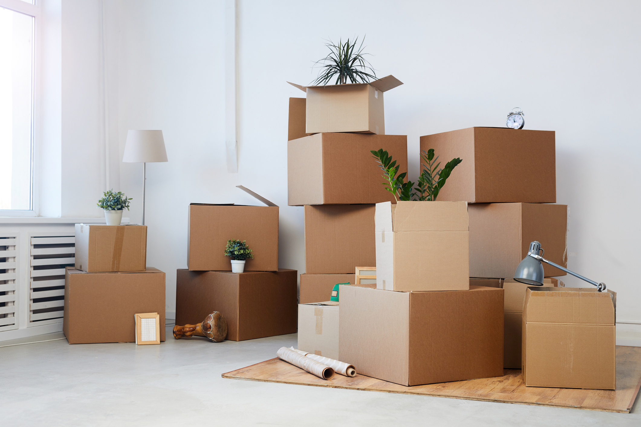 A stack of cardboard boxes in a living room.